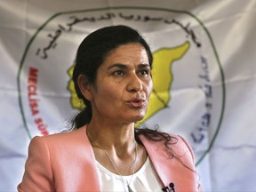 Ilham Ahmed, the co-president of the Syrian Democratic Council, the political wing of the Kurdish-led forces backed by the US in Raqqa, speaks during an interview with the Associated Press, in Kobani town, north Syria, Tuesday, July 25, 2017. Ahmed says the governing and securing of the Arab-majority city after the expulsion of IS militants will be a model for other areas in Syria and the future of governing the war-torn country. She says the Kurdish-led effort needs US political and financial support. (AP Photo/Hussein Malla)