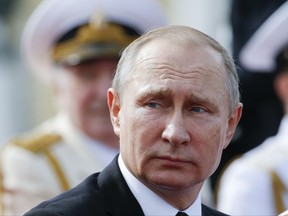 Russian President Vladimir Putin looks on attending the military parade during the Navy Day celebration in St.Petersburg, Russia