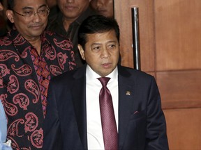FILE - In this Monday, Dec. 7, 2015 file photo, Indonesian House Speaker Setya Novanto, center, leaves after attending the Parliament's Ethics Council hearing in Jakarta, Indonesia. Indonesia's anti-graft agency has named Novanto as a suspect in a corruption scandal in which officials allegedly pocketed more than $170 million in government money. (AP Photo/Tatan Syuflana, File)