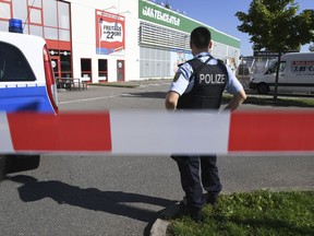 A policeman guards in front of a discotheque in Constance, at Lake Constance, Germany, Sunday, July 30, 2017.