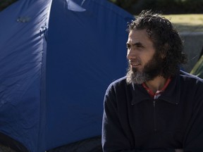 FILE - In this May 5, 2015 file photo, Abu Wa'el Dhiab, from Syria, sits in front of the U.S. embassy while visiting former fellow detainees demanding financial assistance from the U.S., in Montevideo, Uruguay. Authorities reported on Monday, July 24, 2017, that Dhiab has returned to Uruguay after being deported from Morocco. (AP Photo/Matilde Campodonico, File)