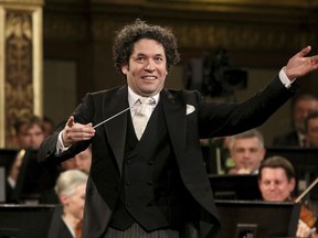 FILE - In this Jan. 1, 2017 file photo, Maestro Gustavo Dudamel, of Venezuela, conducts the Vienna Philharmonic Orchestra during the traditional New Year's Concert at the Golden Hall of the Musikverein in Vienna, Austria. Dudamel joined opposition voices from his native country on Wednesday, July 19, 2017 against the proposal to rewrite Venezuela's constitution proposed by Venezuelan President Nicolas Maduro. (AP Photo/Ronald Zak, File)