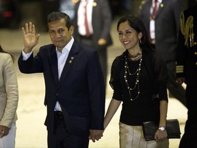 FILE - In this July 2, 2015, file photo, Peru's President Ollanta Humala waves to the press while arriving with his wife, Nadine Heredia, to the closing ceremony of the Business Summit in Paracas, Peru. On Tuesday, July 11, 2017, Peruvian prosecutors asked for jail for the former first couple in a corruption case. (AP Photo/Rodrigo Abd, File)