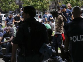 Italian Police check people during a blitz outside Milan's main train station, Italy, Wednesday, July 26, 2017. Authorities have detained several dozen people  in response to an increasing public security issue as the city deals with a new wave of migrants.  (AP Photo/Luca Bruno)