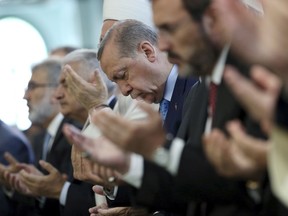 Turkey's President Recep Tayyip Erdogan, offers his prayers, during a prayer for the victims of the July 15, 2016 failed coup attempt, at the mosque of the Presidential Palace in Ankara, Turkey, Friday, July 14, 2017. Turkey commemorates the first anniversary of the July 15 failed military attempt to overthrow Erdogan, with a series of events honoring some 250 people, who were killed across Turkey while trying to oppose coup-plotters. (Presidency Press Service via AP, Pool)