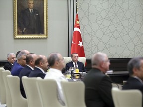 Turkey's President Recep Tayyip Erdogan, centre, chairs the National Security Council meeting in Ankara, Turkey, Monday, July 17, 2017. Erdogan says the country's top security advisory body will discuss on Monday whether to further extend a state of emergency that was declared after last year's failed coup. Erdogan also said he would approve "without any hesitation" any legislation that would be passed in parliament to reinstate the death penalty. (Presidency Press Service Pool Photo via AP)
