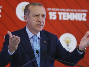 Turkey's President Recep Tayyip Erdogan gestures as he delivers a speech during a ceremony marking the July 15, 2016 failed coup attempt anniversary, in Ankara, Turkey, Friday, July 14, 2017. Turkey commemorates the first anniversary of the July 15 failed military attempt to overthrow Erdogan, with a series of events honouring some 250 people who were killed across Turkey while trying to oppose coup-plotters.(Presidency Press Service/Pool Photo via AP)