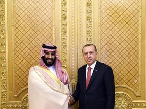 Turkey's President Recep Tayyip Erdogan, right, shakes hands with Saudi Crown Prince Mohammed bin Salman, prior to their meeting in Jiddah, Saudi Arabia, Sunday, July, 23, 2017. Erdogan is in a two day tour in the Middle East, that will take him to Saudi Arabia, Kuwait and Qatar. (Presidency Press Service/Pool Photo via AP)