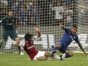 CAPTION CORRECTS THE NAME - Arsenal's Mohamed El Neny, left, tackles Chelsea's Kenedy during the second half of their friendly soccer match in Beijing, Saturday, July 22, 2017. Chelsea beat Arsenal 3-0. (AP Photo/Mark Schiefelbein)