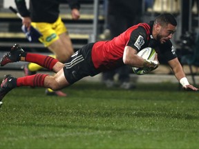 Crusaders Bryn Hall dives across the line to score a try against the Chiefs during their Super Rugby semifinal in Christchurch, New Zealand, Saturday, July 29, 2017. (AP Photo/Mark Baker)