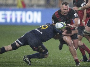 Crusaders Israel Dagg is tackled by Highlanders Alex Ainley during their Super Rugby quarterfinal in Christchurch, New Zealand, Saturday, July 22, 2017.The Crusaders defeated the Highlanders 17-0. (AP Photo/Mark Baker)