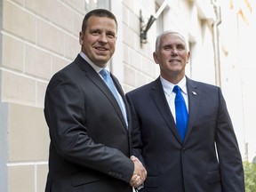 U.S. Vice President Mike Pence, right, and Estonia's Prime Minister Juri Ratas pose for photographers prior to their meeting at the Government palace in Tallinn, Estonia, Sunday, July 30, 2017. Pence arrived in Tallinn for a two day visit where he will meet Baltic States leaders to discuss regional security issues as well as economic and political topics. (AP Photo/Mindaugas Kulbis)