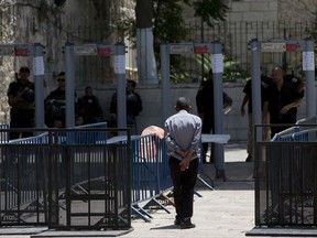 A Palestinian man walks towards a metal detector at the Al Aqsa Mosque compound in Jerusalem's Old City, Wednesday, July 19, 2017. A dispute over metal detectors has escalated into a new showdown between Israel and the Muslim world over the contested Jerusalem shrine that has been at the center of violent confrontations in the past. (AP Photo/Oded Balilty)