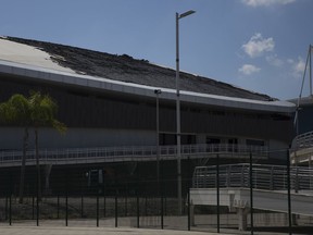 The charred roof of the velodrome is seen at the Olympic Park, Sunday, July 30, 2017, in Rio de Janeiro, Brazil. The velodrome built for last year's Rio de Janeiro Olympics suffered minor fire damage Sunday when it was struck by a small, hand-made hot-air balloon. (AP Photo/Renata Brito)