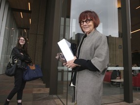 Prof. Jenny Hocking arrives at the Federal Court in Sydney, Monday, July 31, 2017. Hocking, a Monash University historian, is asking the court to force the National Archives of Australia to release the letters between the British monarch, who is also Australia's constitutional head of state, and her former Australian representative, Governor-General Sir John Kerr. (AP Photo/Rick Rycroft)