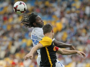 Dynamo Kiev's Dieumerci Mbokani, left, and Young Boys' Steve von Bergen jump for the ball during the Champions League third qualifying round, 1st leg soccer match between Dynamo Kiev and Young Boys at the Olympiyskiy Stadium in Kiev, Ukraine, Wednesday, July 26, 2017. (AP Photo/Efrem Lukatsky)