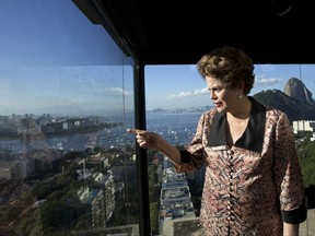 Brazil's former President Dilma Rousseff looks out over Guanabara Bay, before the start of an interview at the offices of the Associated Press in Rio de Janeiro, Brazil, Friday, July 14, 2017. Rousseff says the corruption conviction of her mentor and predecessor Luiz Inacio Lula da Silva is aimed at keeping him out of next year's presidential election. Rousseff was impeached last year for manipulating the fiscal budget. (AP Photo/Silvia Izquierdo)