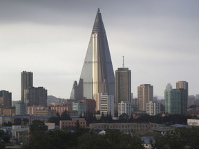 The sky is overcast at the end of a work day on Monday, July 17, 2017, in Pyongyang, North Korea, where the 105-story pyramid-shaped Ryugyong Hotel is seen in this photograph towering over residential apartments. The hotel has been under construction since 1987 and was intended to be a landmark and a symbol of progress and prosperity, but the economic difficulties that the country went through forced the project into repeated delays and nearly 30-years later, it has become a major Pyongyang landmark but has never been used as a hotel, as it was intended. (AP Photo/Wong Maye-E)