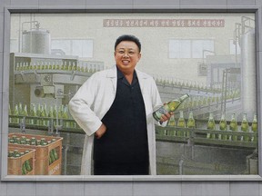 In this Wednesday, July 26, 2017, photo, a mural of the late North Korean leader Kim Jong Il in a white lab coat holding up a bottle of beer is seen at the entrance of the Taedonggang Brewery in Pyongyang, North Korea. Taedonggang beers are generally reputed to be world-class, which is a matter of national pride among many North Koreans. (AP Photo/Wong Maye-E)