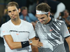 In this Jan. 29 file photo, Rafael Nadal (left) and Roger Federer are shown after the Australian Open final.