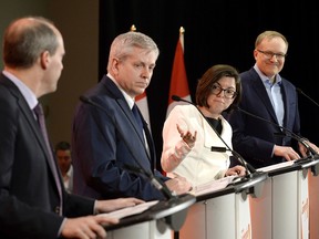 Niki Ashton, second from right, speaks with Guy Caron, left, as Charlie Angus and Peter Julian look on during the first debate of the federal NDP leadership race, in Ottawa on Sunday, March 12, 2017.