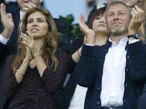 Roman Abramovich and his wife Dasha Zhukova applaud during the Champions League final on May 19, 2012, between Bayern Munich and Chelsea in Munich.