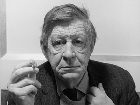 Portrait of American poet W. H. Auden (aka Wystan Hugh Auden) looking into the camera holding a cigarette.