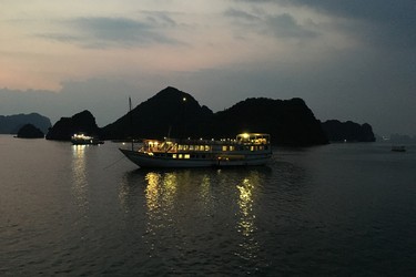 Junk boats anchor for the night in Halong Bay.