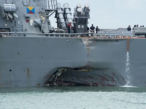 Damage to the portside is visible as the Guided-missile destroyer USS John S. McCain following a collision with the merchant vessel Alnic MC