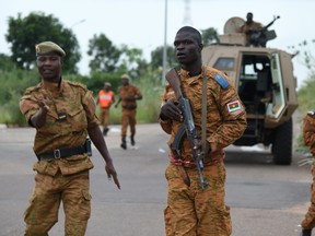 Soldiers of Burkina Faso's loyalist troops stand guard near the Naba Koom II barracks, the base of the Presidential Security Regiment (RSP) in Ouagadougou