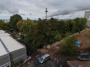 A police car stands next to a blue tent covering a British World War II bomb that was found during construction works, on August 31, 2017 in Frankfurt am Main, western Germany. The disposal of the bomb that is planned for Sunday, September 3, 2017 requires the evacuation of up to 70,000 people.