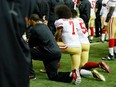 In this Dec. 18, 2016 file photo, Colin Kaepernick kneels during the national anthem before a game against the Atlanta Falcons.