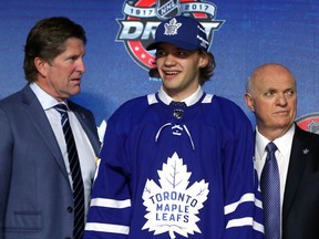 Timothy Liljegren (centre) poses for photos with Toronto Maple Leafs coach Mike Babcock (left) and GM Lou Lamoriello at the NHL draft in Chicago on June 25.
