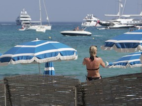 A bather on a private beach in Ramatuelle, near Saint-Tropez, on the southern coast of France in a file photo. In the bay of Saint-Tropez, the number of yachts are more scarce than in the past.