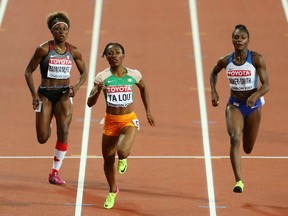 Crystal Emmanuel of Canada, left, follows Marie-Josee Ta Lou and Dina Asher-Smith across the finish line in their women's 200-metre semifinal during Day 7 of the world athletics championships in London on Aug. 10, 2017.