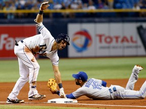 Kevin Kiermaier of the Tampa Bay Rays slides safely into third base ahead of the tag of Toronto Blue Jays third baseman Jose Bautista after hitting a two-run triple during the second inning of their game on Tuesday night at Tropicana Field in St. Petersburg, Fla.