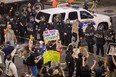 Police prepare to advance upon demonstrators after a rally by President Donald Trump at the Phoenix Convention Center on August 22, 2017 in Phoenix, Arizona