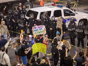 Police prepare to advance upon demonstrators after a rally by President Donald Trump at the Phoenix Convention Center on August 22, 2017 in Phoenix, Arizona