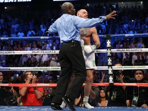 Referee Robert Byrd stops the fight in round 10 with a TKO of Conor McGregor by Floyd Mayweather Jr. in their super welterweight boxing match on Saturday night at T-Mobile Arena in Las Vegas.