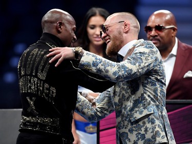 Floyd Mayweather Jr. and Conor McGregor shake hands at the post-fight news conference.