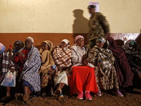 Kenyan women queue before dawn for the polls to open in Gatundu, north of Nairobi, Kenya Tuesday, Aug. 8, 2017. Kenyans are going to the polls to vote in a general election after a tightly-fought presidential race between incumbent President Uhuru Kenyatta and main opposition leader Raila Odinga. (AP Photo/Ben Curtis)
