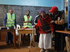 Lydia Gathoni Kiingati, 102, walks to cast her vote just after dawn at a polling station in Gatundu, north of Nairobi, Kenya, Tuesday, Aug. 8, 2017. Kenyans are going to the polls to vote in a general election after a tightly-fought presidential race between incumbent President Uhuru Kenyatta and main opposition leader Raila Odinga. (AP Photo/Ben Curtis)