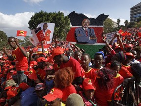 A supporter holds a painting of Kenya's President Uhuru Kenyatta at an election rally in Uhuru Park