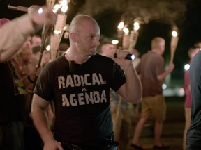In this Friday, Aug. 11, 2017, image made from a video provided by Vice News Tonight, Christopher Cantwell attends a white nationalist rally in Charlottesville, Va.