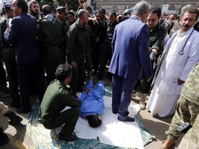 A doctors stands close to Yemeni security forces preparing to execute a man convicted of raping and murdering a three-year-old girl in the Yemeni capital Sanaa's Tahrir Square on July 31, 2017