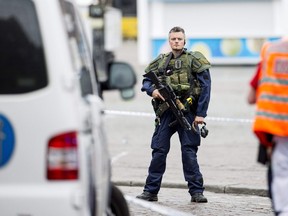 An armed police officer stands guard at the Turku Market Square in the Finnish city of Turku where several people were stabbed on August 18, 2017