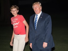 U.S. President Donald Trump returns to the White House with his son Barron in Washington, D.C., on August 20, 2017.
