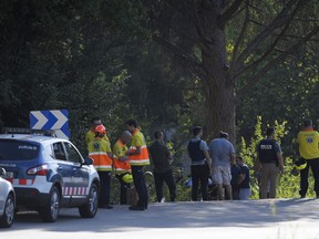 Policemen and medical staff stand at the site where Moroccan suspect Younes Abouyaaqoub was shot on August 21, 2017 near Sant Sadurni d'Anoia, south of Barcelona, four days after the Barcelona and Cambrils attacks that killed 15 people.