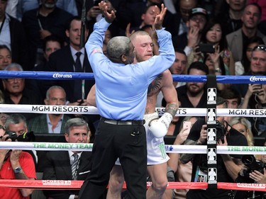 Referee Richard Byrd steps in front of Conor McGregor to stop the fight in the 10th round against Floyd Mayweather Jr.