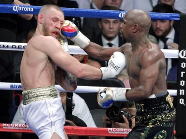 Floyd Mayweather Jr. lands a right to the face of Conor McGregor.